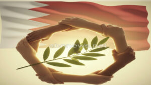 شعار رمزي يجمع أيادي مترابطة مع غصن زيتون أمام علم البحرين، يمثل قيم الجمعية البهائية الاجتماعية في التعايش السلمي، موقع abnnews.net.