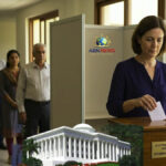 A person casting a secret ballot in a Baha'i administrative election for a Local Spiritual Assembly.